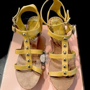 Juicy Couture wood and leather platforms with gold buttons.